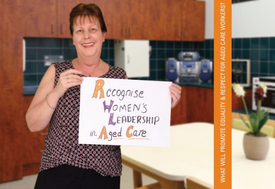 Image of a migrant woman working in aged care holding a sign that reads 'Recognise Women's Leadership in Aged Care'