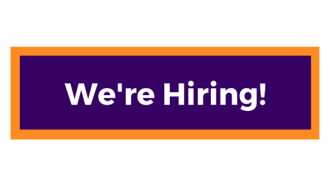 Alt text: A centralised purple rectangle with orange edge, with the words ‘we’re hiring’ written in bold white text to get your attention, as we’d love you to apply for these exciting positions with us! 