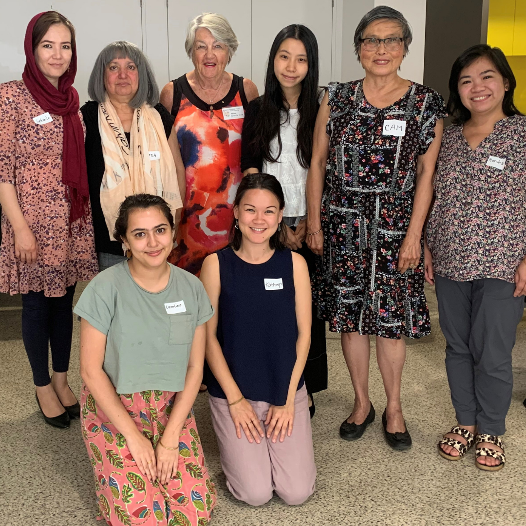Image of eight women standing together and smiling at the Community of Practice